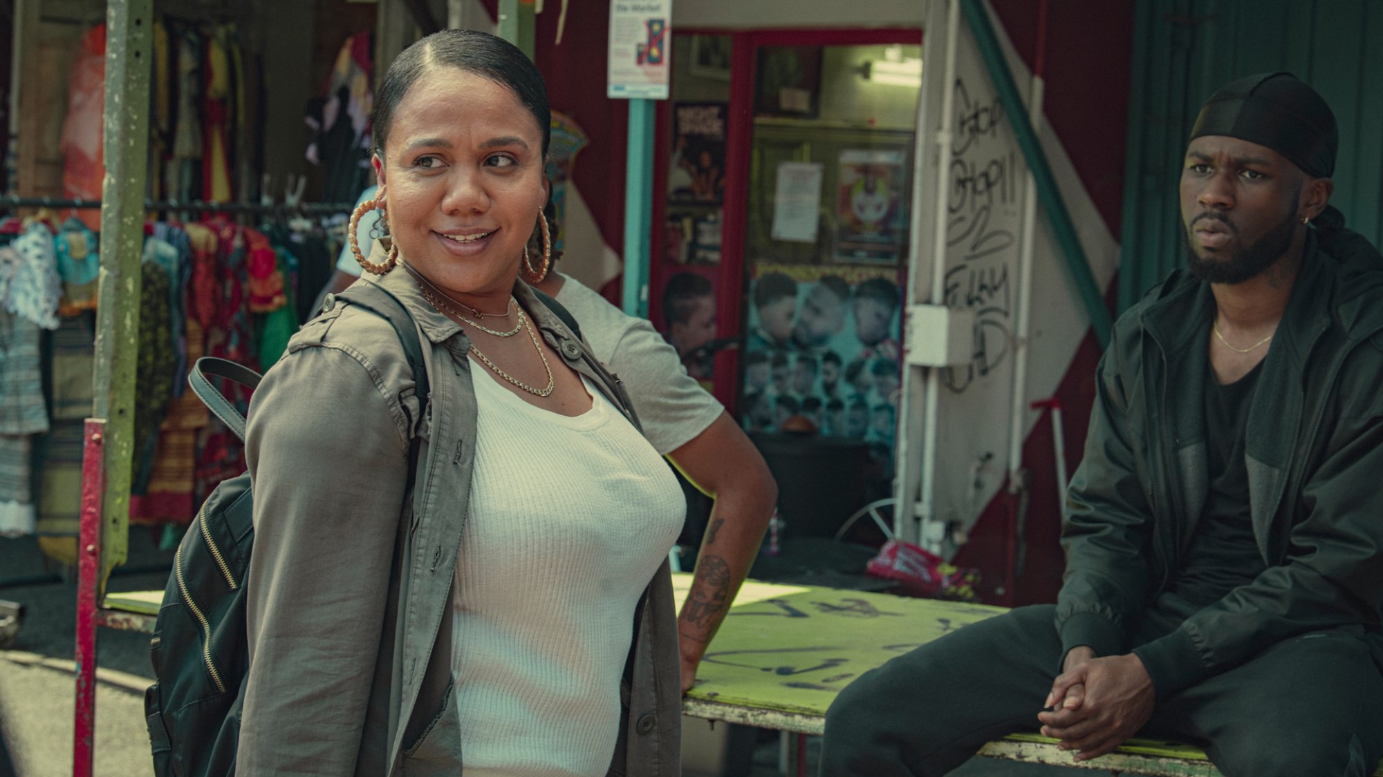 NoLay stands chatting to Joshua Blissett in a market in the show "Top Boy"